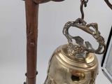 a bell that is sitting on a stand next to a picture frame