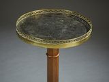 a close up of a brass plate on a wooden stand