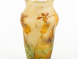 a glass vase with flowers painted on it on a white surface