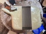 a white electric guitar sitting on top of a table