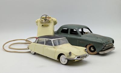two toy cars sitting next to each other on a white surface