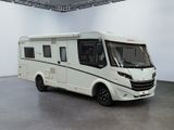an image of a white motorhome parked in a garage