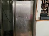 a stainless steel refrigerator in the corner of a kitchen