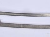 two old swords are laying on a white surface
