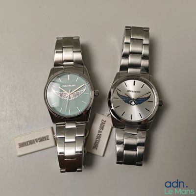 two watches sitting next to each other on a table