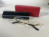 pair of glasses and case on a white surface with a red box