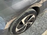 a close up of a car ' s tire on the side of the road