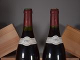 two bottles of wine that are sitting on a table