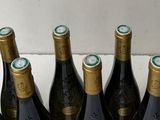 several bottles of wine are lined up in a row on a counter