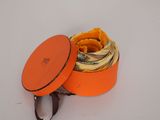 an orange box with a pair of scissors in it