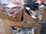 two boxes of clothing sitting on a pallet in a warehouse