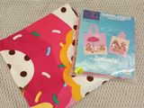 a close up of a blanket and a book on a bed