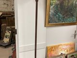 a lamp that is sitting on a table next to a painting