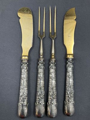 a set of four antique silverplated knives and forks