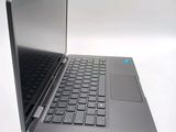 a laptop computer sitting on a white surface with a blue button