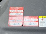 three id cards attached to the hood of a car