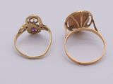 two gold rings with garnets and a pink stone