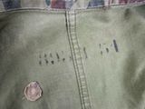 a close up of a military jacket with writing on it