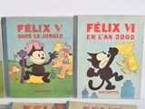 three children ' s books are lined up on a white surface
