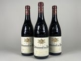 three bottles of wine sitting on top of a table next to each other