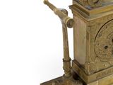 a gold clock that is sitting on top of a table
