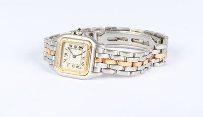 a silver and gold wrist watch on a white surface