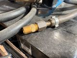 a close up of a hose connected to a car ' s engine