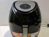 a black and silver air fryer sitting on a counter