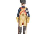 figurine représentant un soldat coiffé d'un bonnet rouge et vêtu d'un uniforme, posée sur un socle en bois