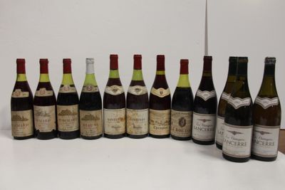 several bottles of wine are lined up in a row on a table