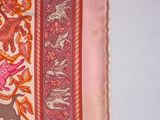a picture of a pink and orange scarf with a picture of a lion on it