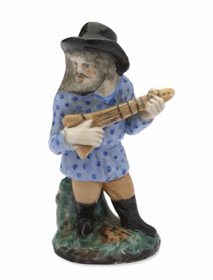 figurine représentant un homme jouant de la guitare sur fond blanc