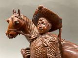 a statue of a man riding a horse with a hat on