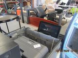 a laptop computer sitting on top of a printer in a room