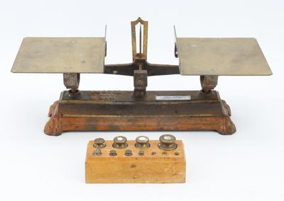 a small scale with a wooden base and a wooden stand