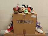 a pile of shoes sitting on top of a cardboard box