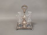 an image of a silver plate with four glasses and a candle holder