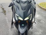 a motorcycle that is parked on the street in the rain