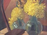 yellow flowers in a vase on a table with a mirror in the background