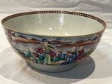 a bowl with a painting on it sitting on a table