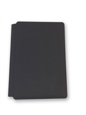 a close up of a black notebook on a white surface