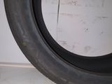 a tire that is sitting on the floor next to a wall