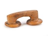 a small wooden object on a white surface