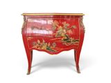 une commode rouge décorée d'un tableau