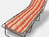 an orange and white striped folding bed on a metal frame