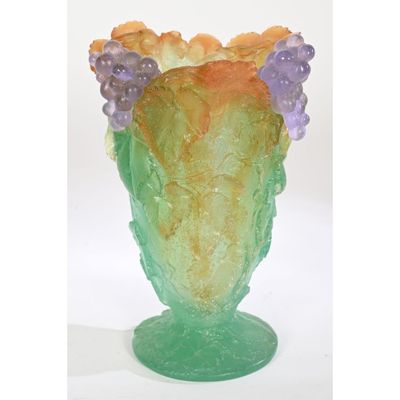 a glass vase with a bunch of grapes in it