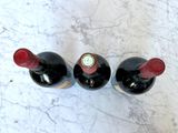 three bottles of wine sitting on a marble table