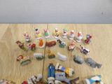a lot of small figurines on a wooden table