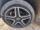a tire that is sitting on the ground next to a car