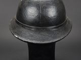 an old helmet is sitting on top of a black base
